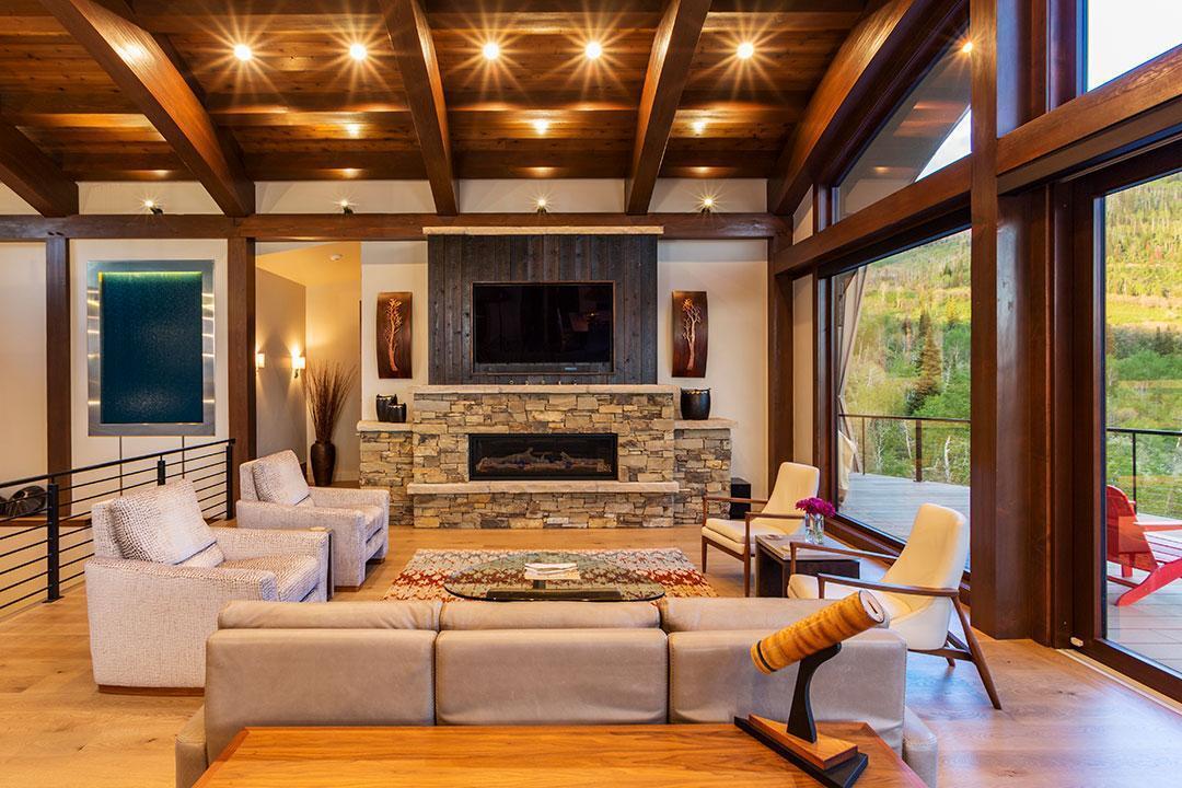 Living Room With Fireplace in Timber Frame Home by Woodhouse, The Timber Frame Company