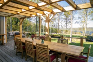 A wooden banquet on a porch under timber frames.