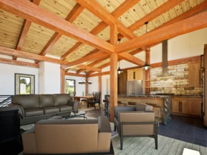 Open-concept great room inside the CreekRock V2 timber frame floor plan featuring exposed timber beams, vaulted tongue-and-groove wood ceiling, stone accent wall, kitchen island with seating, and adjacent dining area.