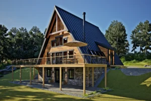 Rear view of the AspenValley timber frame A-frame house showing expansive deck, large windows, and stone foundation beneath the elevated living space.