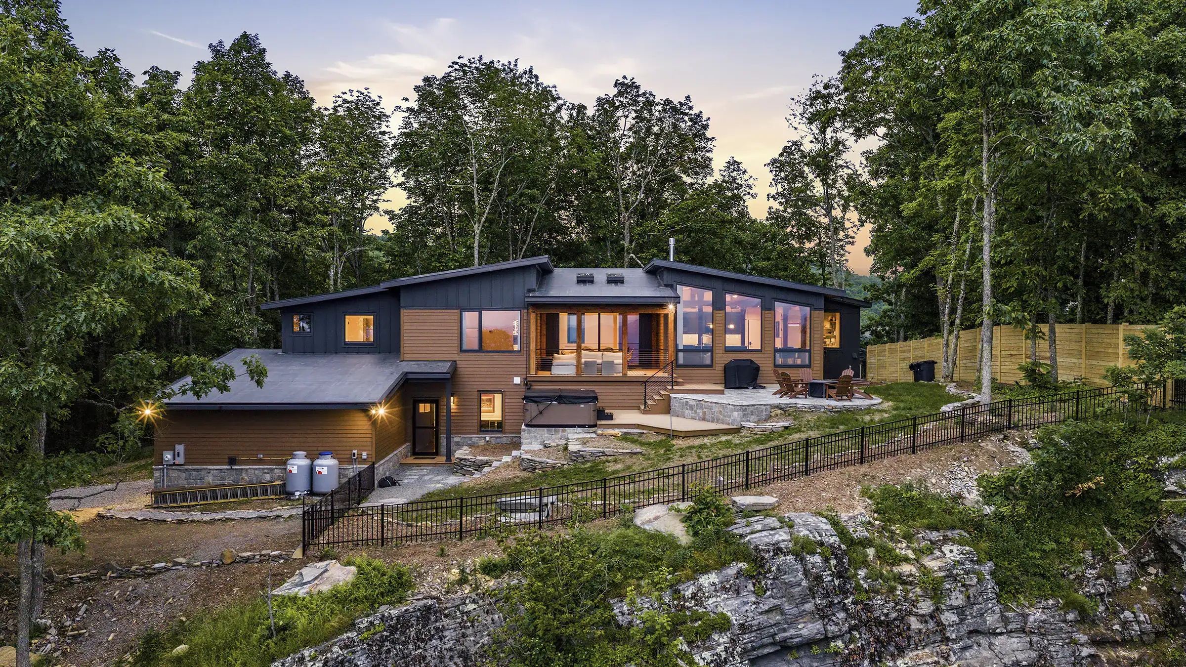 Custom contemporary timber frame home overlooking the mountains on Snakeden Mountain, featuring exposed timber framing, expansive windows, and a modern architectural design.